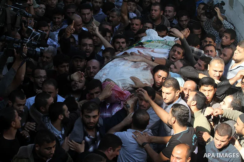 Palestinian mourners carry the body of Ahmad Jaabari, head of the military wing of the Hamas movement, the Ezzedin Qassam Brigades, during his funeral in Gaza City, on November 15, 2012. Tensions between Israel and Gaza...