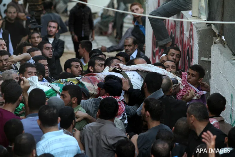 Palestinian mourners carry the body of Ahmad Jaabari, head of the military wing of the Hamas movement, the Ezzedin Qassam Brigades, during his funeral in Gaza City, on November 15, 2012. Tensions between Israel and Gaza...