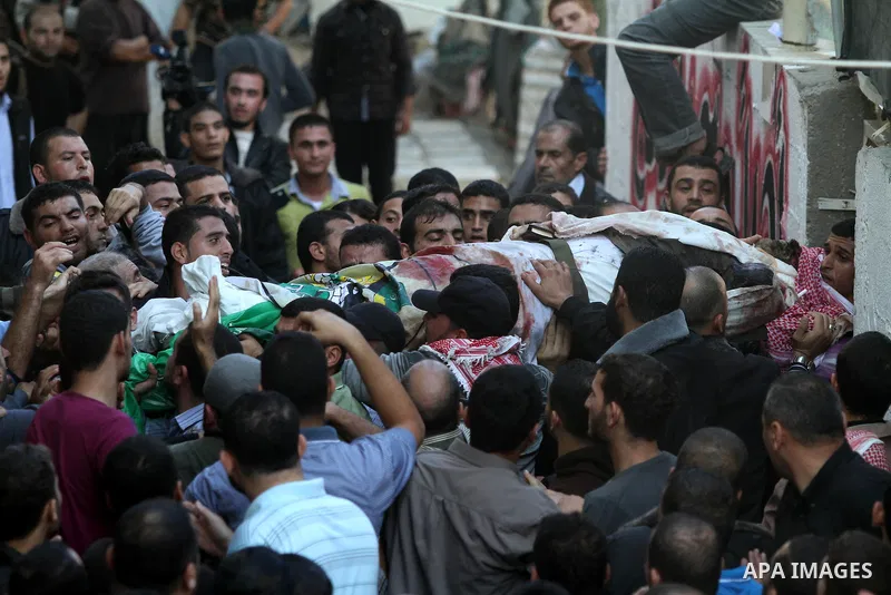 Palestinian mourners carry the body of Ahmad Jaabari, head of the military wing of the Hamas movement, the Ezzedin Qassam Brigades, during his funeral in Gaza City, on November 15, 2012. Tensions between Israel and Gaza...