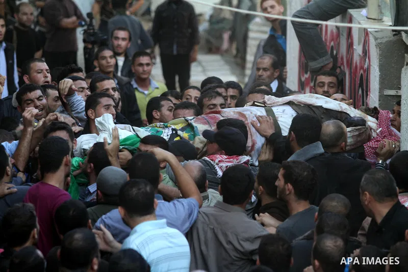 Palestinian mourners carry the body of Ahmad Jaabari, head of the military wing of the Hamas movement, the Ezzedin Qassam Brigades, during his funeral in Gaza City, on November 15, 2012. Tensions between Israel and Gaza...