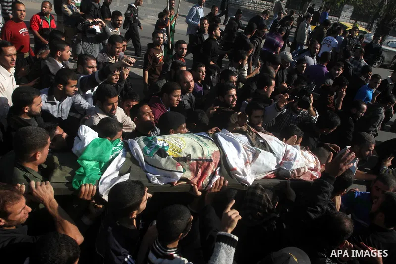 Palestinian mourners carry the body of Ahmad Jaabari, head of the military wing of the Hamas movement, the Ezzedin Qassam Brigades, during his funeral in Gaza City, on November 15, 2012. Tensions between Israel and Gaza...