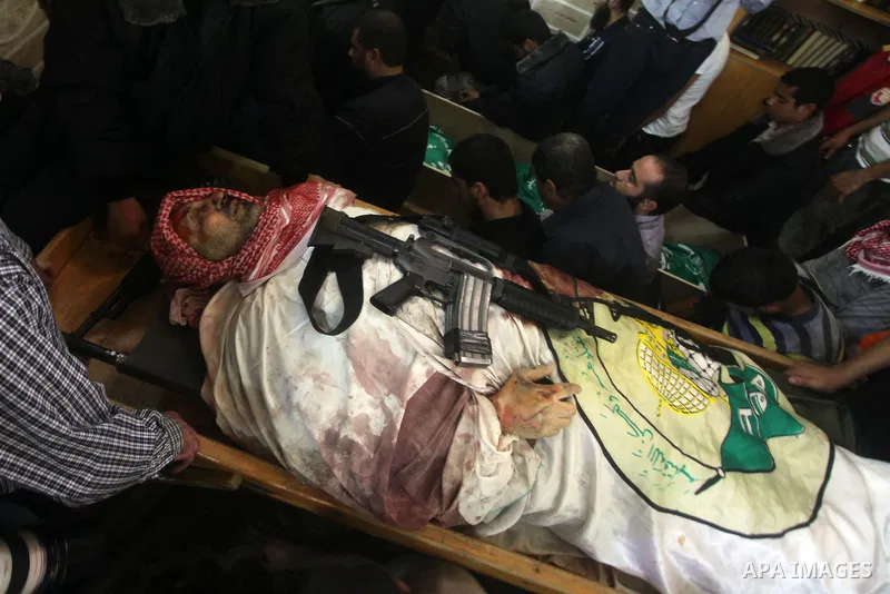 Palestinian mourners carry the body of Ahmad Jaabari, head of the military wing of the Hamas movement, the Ezzedin Qassam Brigades, during his funeral in Gaza City, on November 15, 2012. Tensions between Israel and Gaza...