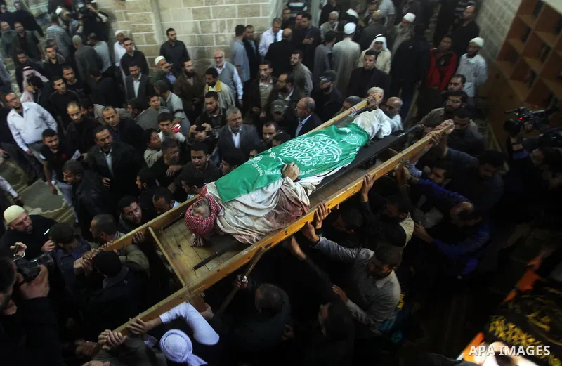 Palestinian mourners carry the body of Ahmad Jaabari, head of the military wing of the Hamas movement, the Ezzedin Qassam Brigades, during his funeral in Gaza City, on November 15, 2012. Tensions between Israel and Gaza...
