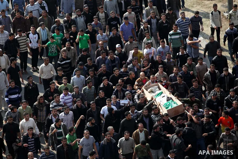 Palestinian mourners carry the body of Ahmad Jaabari, head of the military wing of the Hamas movement, the Ezzedin Qassam Brigades, during his funeral in Gaza City, on November 15, 2012. Tensions between Israel and Gaza...