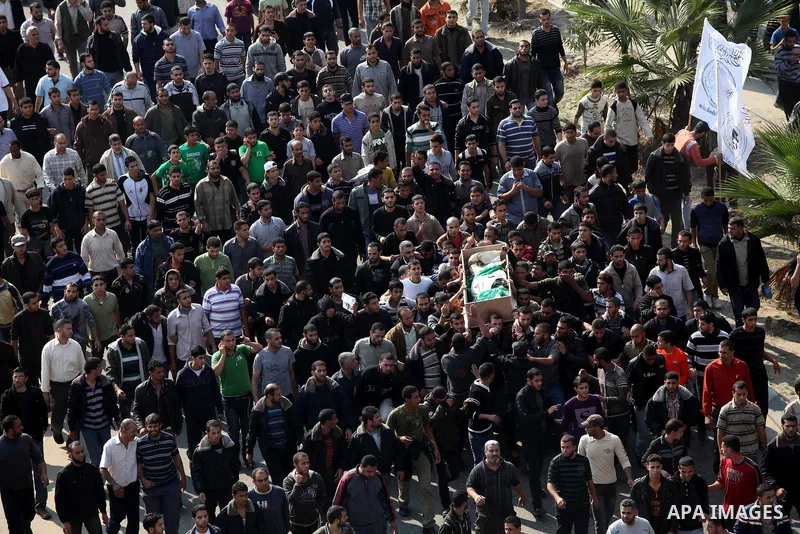 Palestinian mourners carry the body of Ahmad Jaabari, head of the military wing of the Hamas movement, the Ezzedin Qassam Brigades, during his funeral in Gaza City, on November 15, 2012. Tensions between Israel and Gaza...