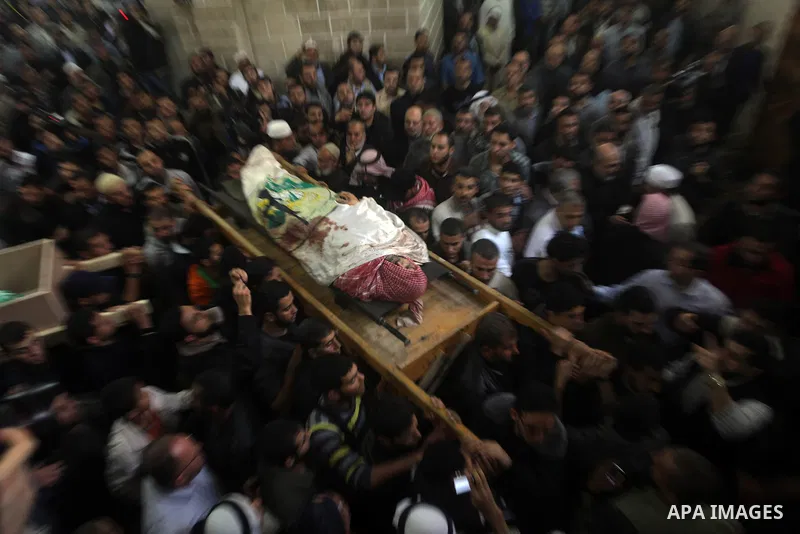 Palestinian mourners carry the body of Ahmad Jaabari, head of the military wing of the Hamas movement, the Ezzedin Qassam Brigades, during his funeral in Gaza City, on November 15, 2012. Tensions between Israel and Gaza...