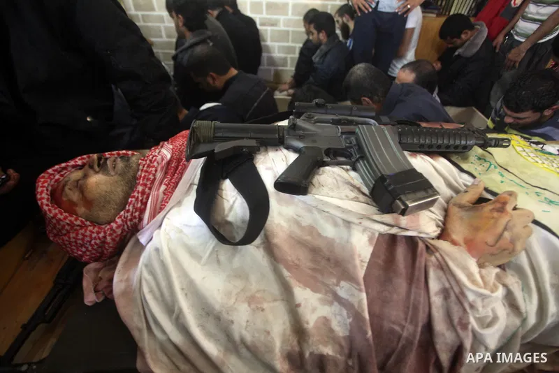 Palestinian mourners carry the body of Ahmad Jaabari, head of the military wing of the Hamas movement, the Ezzedin Qassam Brigades, during his funeral in Gaza City, on November 15, 2012. Tensions between Israel and Gaza...