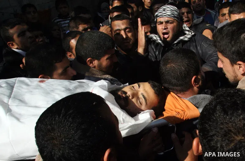 Palestinian relatives of Hisham Ghalban carry his body in Khan Younis in the southern Gaza Strip, on November 15, 2012. Tensions between Israel and Gaza have sparked a furious response from Egypt's Islamist administratio...