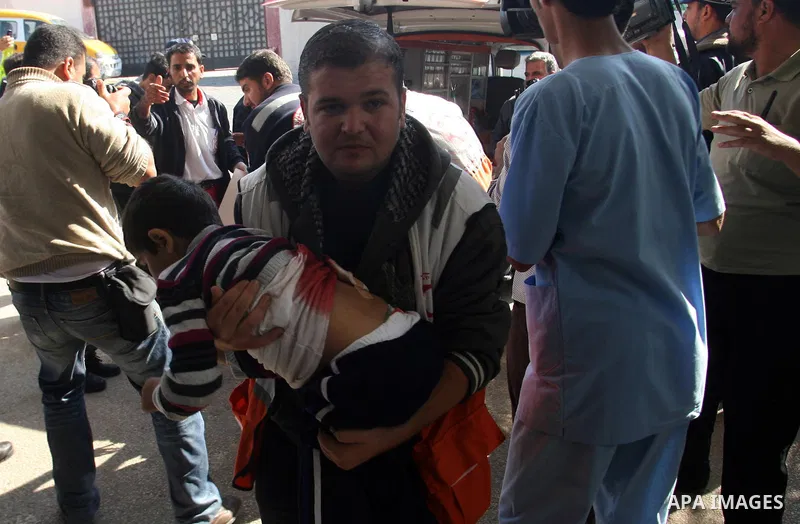 A Palestinian medic carries a wounded boy to the hospital after an Israeli air strike in Khan Younis in the southern Gaza Strip November 15, 2012. Hamas fired dozens of rockets into southern Israel on Thursday, killing t...