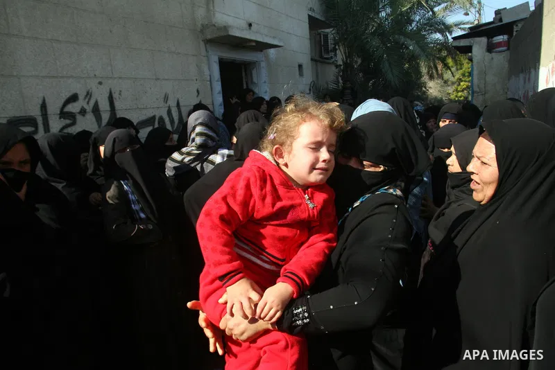 Palestinian relatives of Hisham Ghalban mourn during his funeral in Khan Younis in the southern Gaza Strip, on November 15, 2012. Tensions between Israel and Gaza have sparked a furious response from Egypt's Islamist adm...