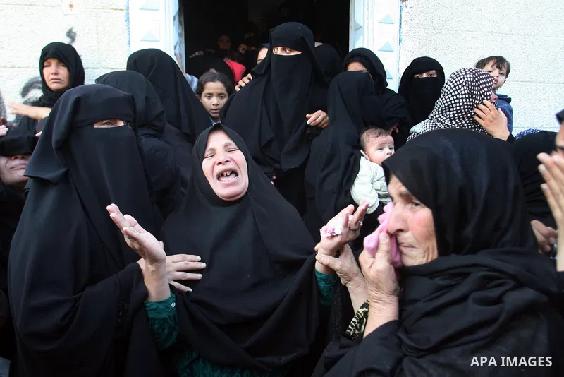 Palestinian relatives of Hisham Ghalban mourn during his funeral in Khan Younis in the southern Gaza Strip, on November 15, 2012. Tensions between Israel and Gaza have sparked a furious response from Egypt's Islamist adm...