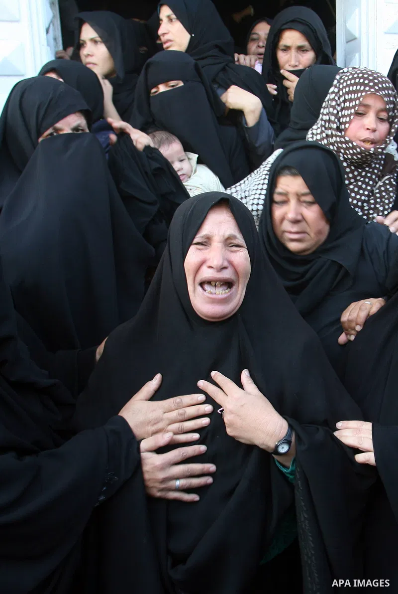 Palestinian relatives of Hisham Ghalban mourn during his funeral in Khan Younis in the southern Gaza Strip, on November 15, 2012. Tensions between Israel and Gaza have sparked a furious response from Egypt's Islamist adm...
