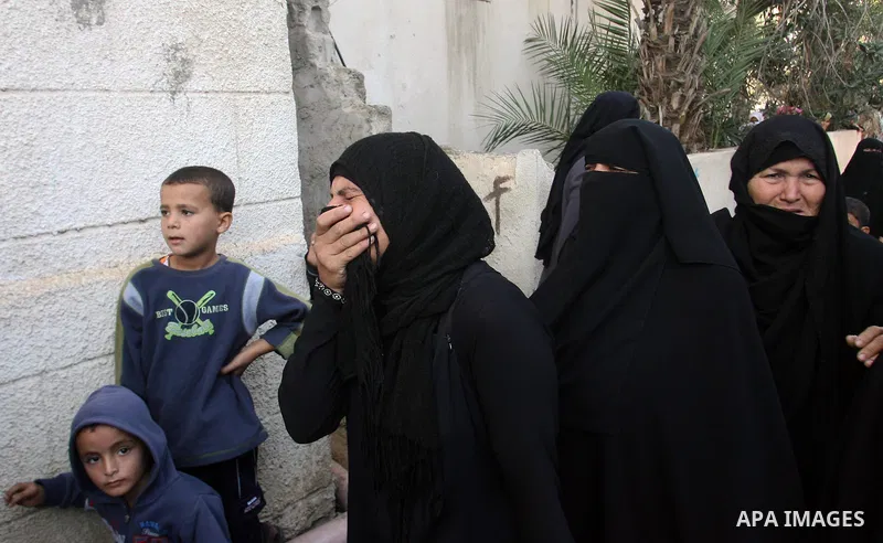 Palestinian relatives of Hisham Ghalban mourn during his funeral in Khan Younis in the southern Gaza Strip, on November 15, 2012. Tensions between Israel and Gaza have sparked a furious response from Egypt's Islamist adm...