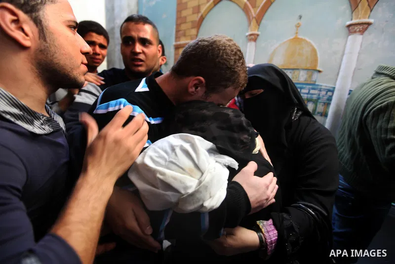 The parents of 11-month-old baby boy Omar al-Masharawi during his funeral in Gaza City, on November 15, 2012. Tensions between Israel and Gaza have sparked a furious response from Egypt's Islamist administration, which h...