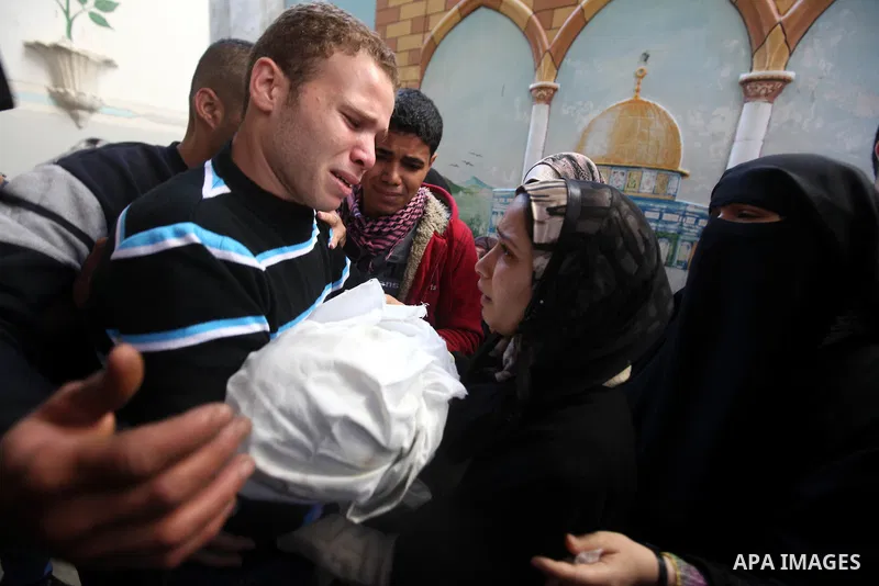 The parents of 11-month-old baby boy Omar al-Masharawi during his funeral in Gaza City, on November 15, 2012. Tensions between Israel and Gaza have sparked a furious response from Egypt's Islamist administration, which h...