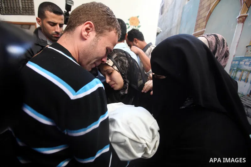 The parents of 11-month-old baby boy Omar al-Masharawi during his funeral in Gaza City, on November 15, 2012. Tensions between Israel and Gaza have sparked a furious response from Egypt's Islamist administration, which h...