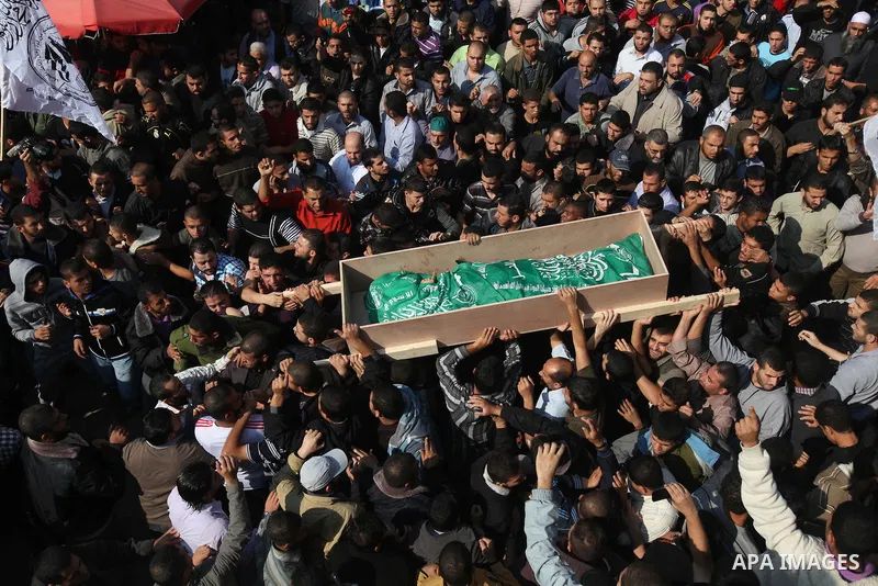 Palestinian mourners carry the body of Ahmad Jaabari, head of the military wing of the Hamas movement, the Ezzedin Qassam Brigades, during his funeral in Gaza City, on November 15, 2012. Tensions between Israel and Gaza...