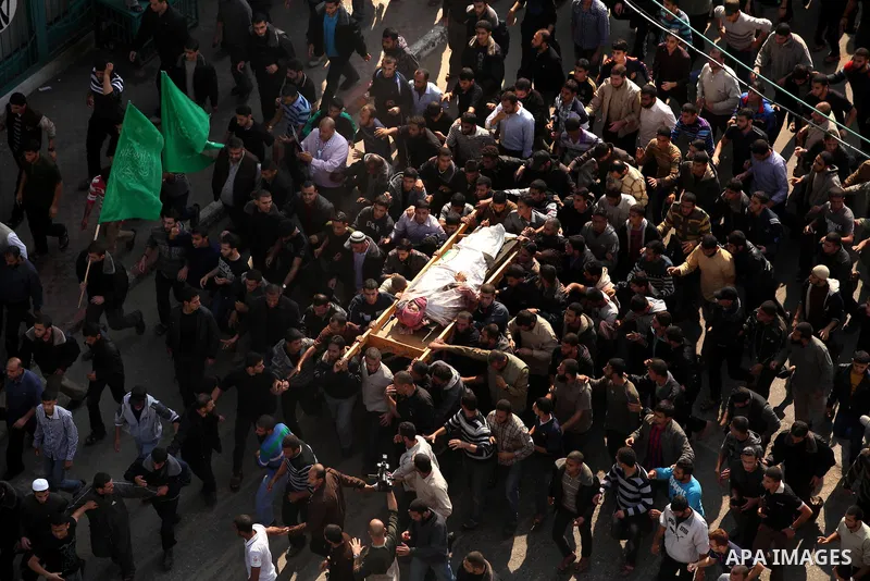 Palestinian mourners carry the body of Ahmad Jaabari, head of the military wing of the Hamas movement, the Ezzedin Qassam Brigades, during his funeral in Gaza City, on November 15, 2012. Tensions between Israel and Gaza...