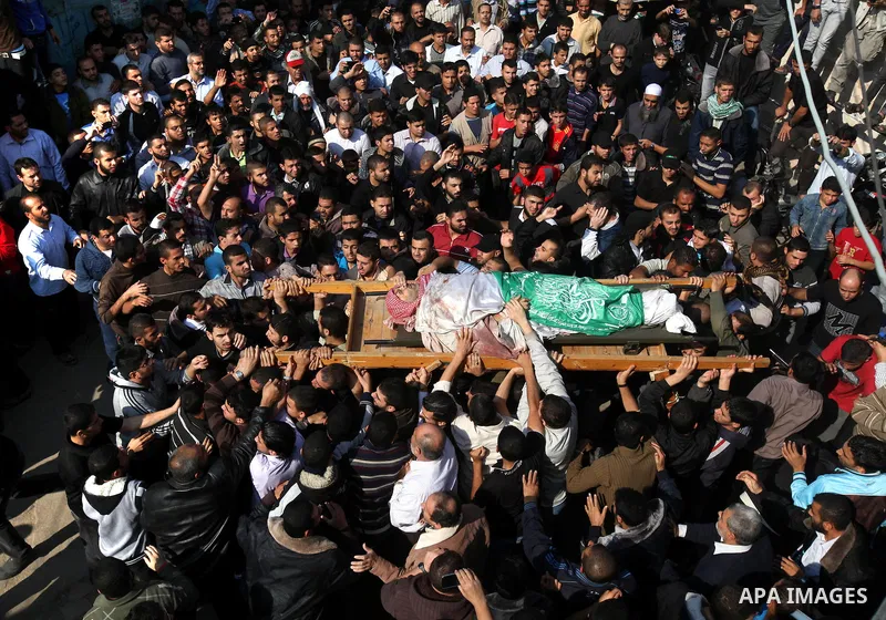 Palestinian mourners carry the body of Ahmad Jaabari, head of the military wing of the Hamas movement, the Ezzedin Qassam Brigades, during his funeral in Gaza City, on November 15, 2012. Tensions between Israel and Gaza...