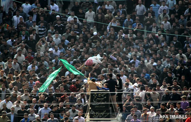 Palestinian mourners carry the body of Ahmad Jaabari, head of the military wing of the Hamas movement, the Ezzedin Qassam Brigades, during his funeral in Gaza City, on November 15, 2012. Tensions between Israel and Gaza...