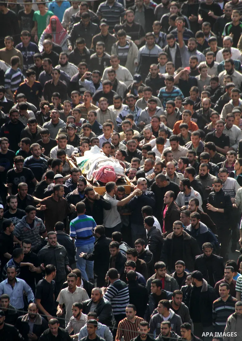 Palestinian mourners carry the body of Ahmad Jaabari, head of the military wing of the Hamas movement, the Ezzedin Qassam Brigades, during his funeral in Gaza City, on November 15, 2012. Tensions between Israel and Gaza...