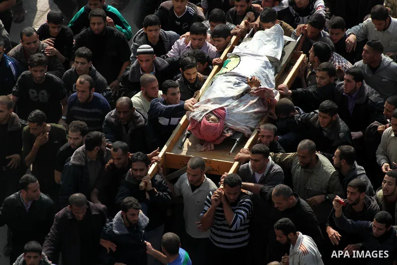 Palestinian mourners carry the body of Ahmad Jaabari, head of the military wing of the Hamas movement, the Ezzedin Qassam Brigades, during his funeral in Gaza City, on November 15, 2012. Tensions between Israel and Gaza...