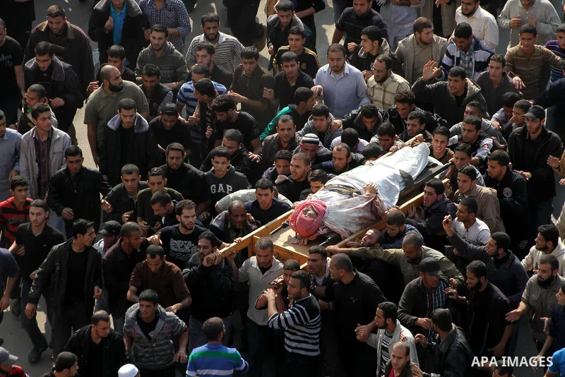 Palestinian mourners carry the body of Ahmad Jaabari, head of the military wing of the Hamas movement, the Ezzedin Qassam Brigades, during his funeral in Gaza City, on November 15, 2012. Tensions between Israel and Gaza...