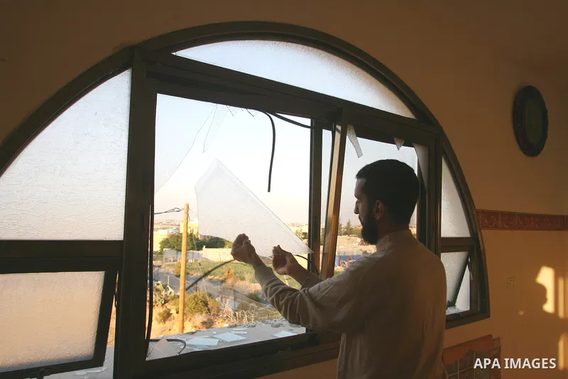 A Palestinian man inspects the damage in his house hit by a missile fired by Israeli air forces in the southern of Gaza strip town of Rafah, November 15, 2012. Several Palestinians were killed following a series of Israe...