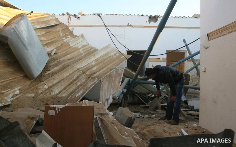 A Palestinian man inspects the damage in his house hit by a missile fired by Israeli air forces in the southern of Gaza strip town of Rafah, November 15, 2012. Several Palestinians were killed following a series of Israe...