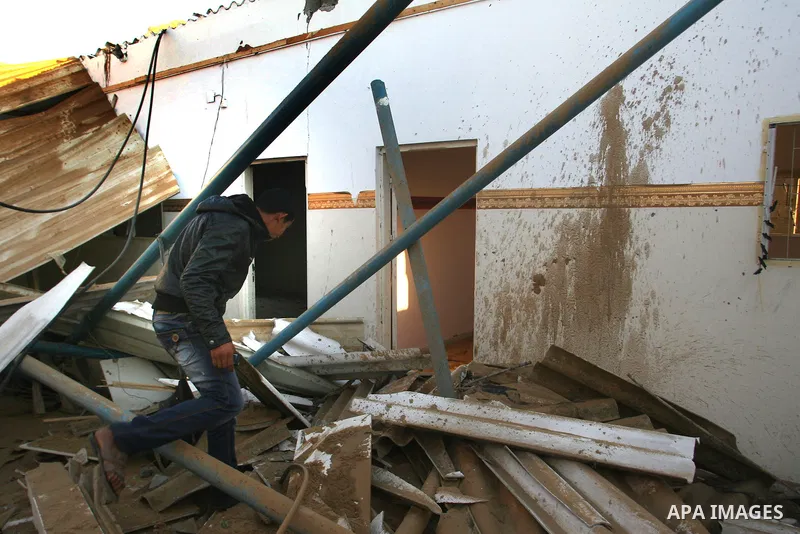 A Palestinian man inspects the damage in his house hit by a missile fired by Israeli air forces in the southern of Gaza strip town of Rafah, November 15, 2012. Several Palestinians were killed following a series of Israe...