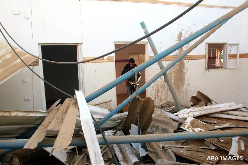 A Palestinian man inspects the damage in his house hit by a missile fired by Israeli air forces in the southern of Gaza strip town of Rafah, November 15, 2012. Several Palestinians were killed following a series of Israe...