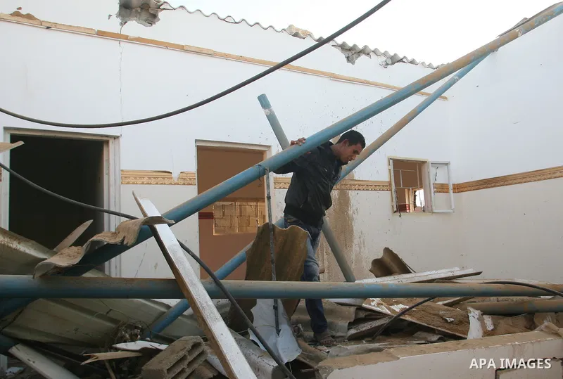 A Palestinian man inspects the damage in his house hit by a missile fired by Israeli air forces in the southern of Gaza strip town of Rafah, November 15, 2012. Several Palestinians were killed following a series of Israe...