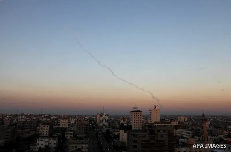 Three rockets fired by Palestinian militants at southern Israel leaves a thin trail of white smoke, seen between buildings in Gaza City, Thursday, Nov. 15, 2012. Militants in the Gaza Strip pounded southern Israel with r...