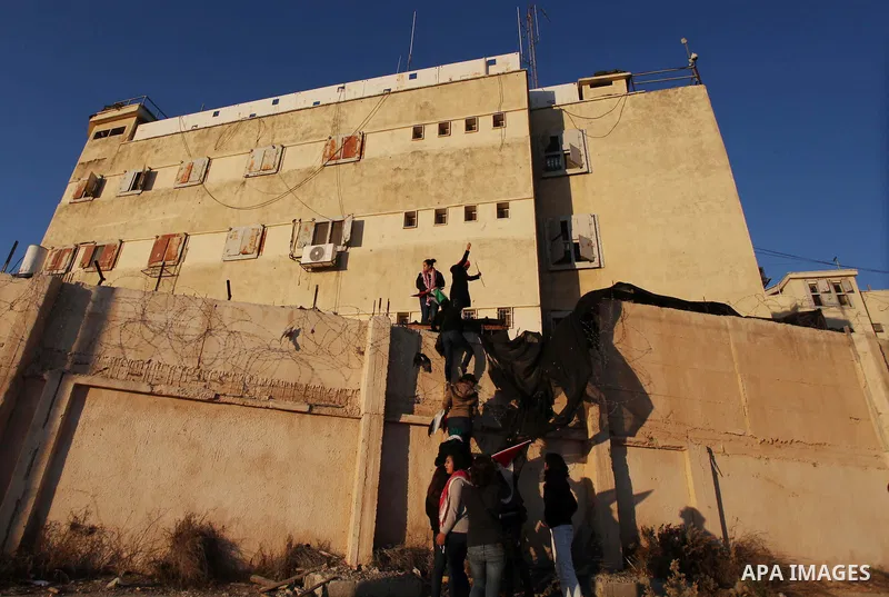 Palestinian feminine activists break inside a military camp near the West Bank city of Ramallah on Nov. 15, 2012. About 20 Palestinian activists Break in Biet Eil militarily camp rising Flags and banners supporting Gaza...