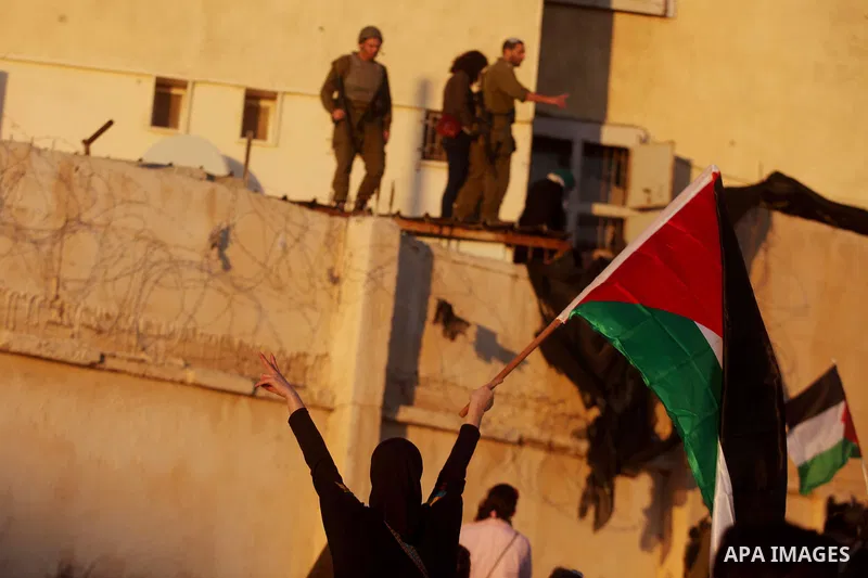 Palestinian feminine activists break inside a military camp near the West Bank city of Ramallah on Nov. 15, 2012. About 20 Palestinian activists Break in Biet Eil militarily camp rising Flags and banners supporting Gaza...