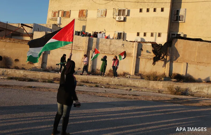 Palestinian feminine activists break inside a military camp near the West Bank city of Ramallah on Nov. 15, 2012. About 20 Palestinian activists Break in Biet Eil militarily camp rising Flags and banners supporting Gaza...