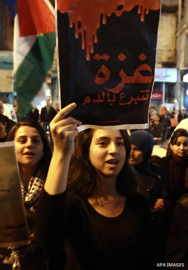Palestinian activists hold placards during a protest against the Israeli military operations in Gaza strip, in the West Bank city of Nablus on November 15, 2012. Several Palestinians were killed following a series of Isr...