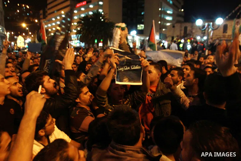 Palestinian activists hold placards during a protest against the Israeli military operations in Gaza strip, in the West Bank city of Nablus on November 15, 2012. Several Palestinians were killed following a series of Isr...