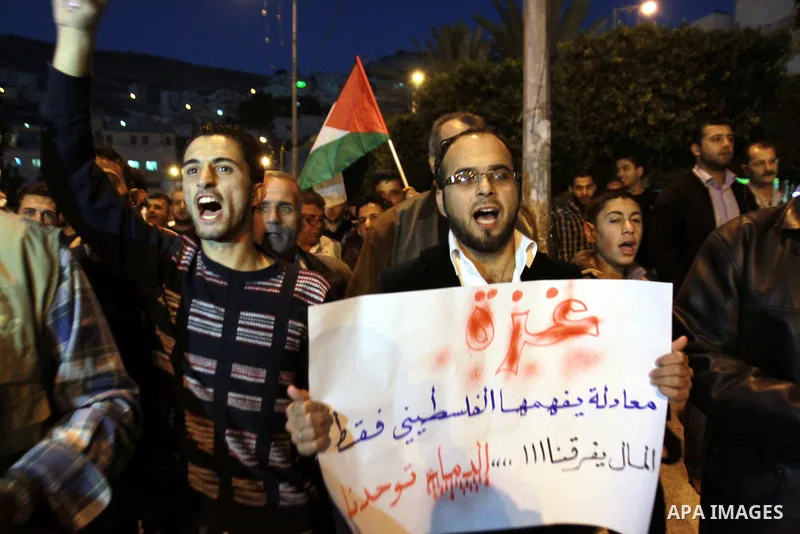 Palestinian activists hold placards during a protest against the Israeli military operations in Gaza strip, in the West Bank city of Nablus on November 15, 2012. Several Palestinians were killed following a series of Isr...