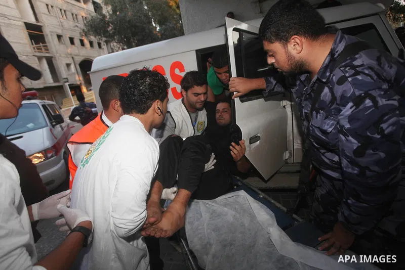 Palestinian rescue teams carry a wounded man following an Israeli air strike on Gaza city on November 15, 2012. Israeli air strikes have killed more than ten Gazans, including top Hamas commander Ahmed Jaabari, as three...