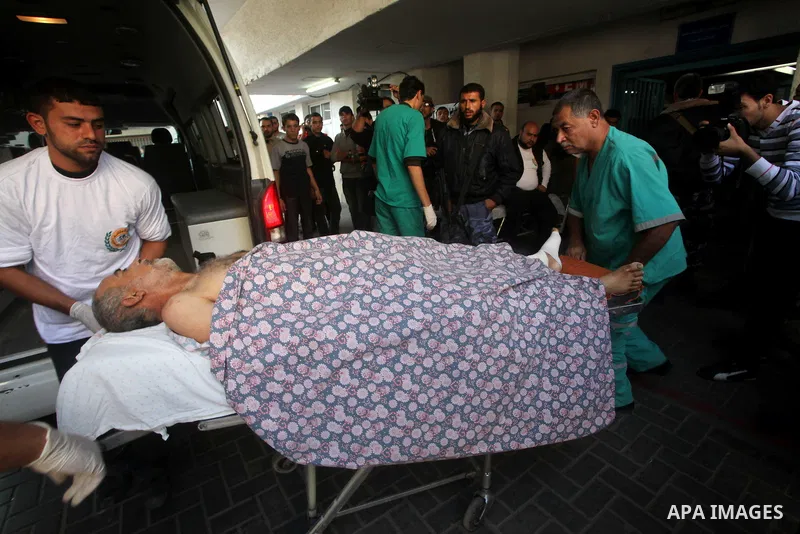 Palestinian rescue teams carry a wounded man following an Israeli air strike on Gaza city on November 15, 2012. Israeli air strikes have killed more than ten Gazans, including top Hamas commander Ahmed Jaabari, as three...