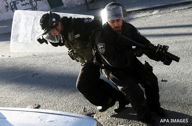 An Israeli security force shot a tear gas canister toward Palestinian demonstrators during clashes in protest to Israel's military operation in Gaza, in the East Jerusalem neighbourhood of Issawiya November 15, 2012. A H...