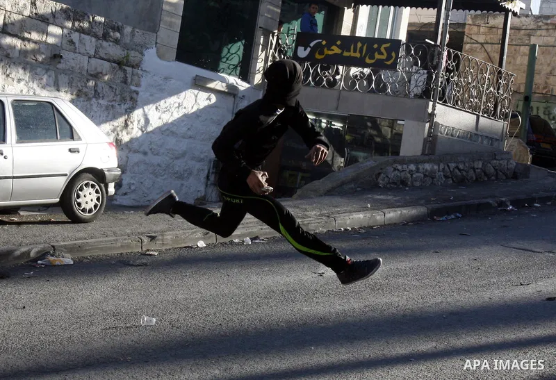 Palestinians throw stones at Israeli security forces (unseen) during clashes in protest to Israel's military operation in Gaza, in the East Jerusalem neighbourhood of Issawiya November 15, 2012. A Hamas rocket killed thr...