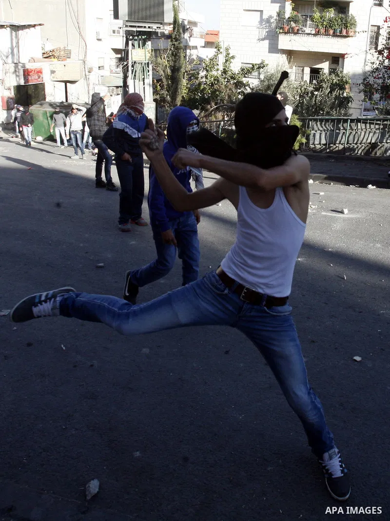 Palestinians throw stones at Israeli security forces (unseen) during clashes in protest to Israel's military operation in Gaza, in the East Jerusalem neighbourhood of Issawiya November 15, 2012. A Hamas rocket killed thr...