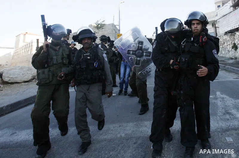 Israeli security officer detains a Palestinian stone-thrower during clashes against Israel's military operation in Gaza, in the East Jerusalem neighbourhood of Issawiya November 15, 2012. A Hamas rocket killed three Isra...