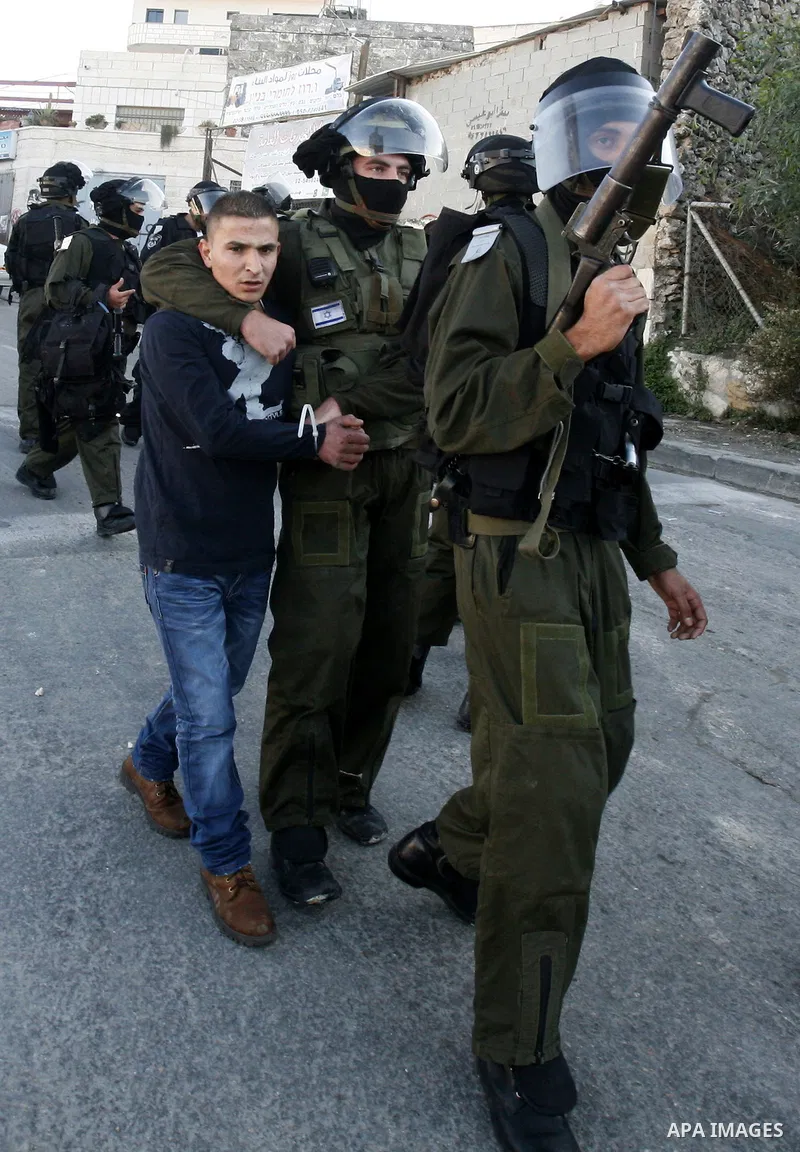 Israeli security officer detains a Palestinian stone-thrower during clashes against Israel's military operation in Gaza, in the East Jerusalem neighbourhood of Issawiya November 15, 2012. A Hamas rocket killed three Isra...