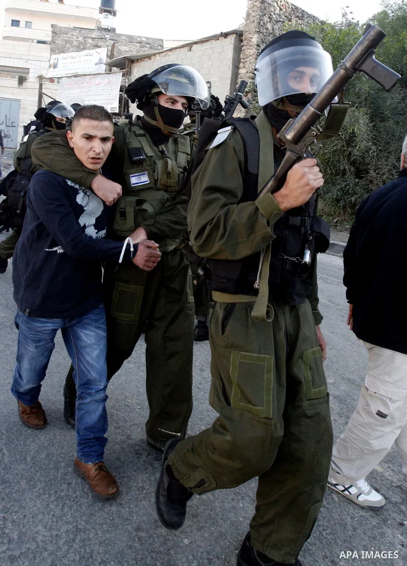 Israeli security officer detains a Palestinian stone-thrower during clashes against Israel's military operation in Gaza, in the East Jerusalem neighbourhood of Issawiya November 15, 2012. A Hamas rocket killed three Isra...