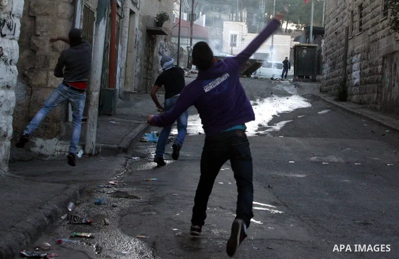 Palestinians throw stones at Israeli security forces (unseen) during clashes in protest to Israel's military operation in Gaza, in the East Jerusalem neighbourhood of Issawiya November 15, 2012. A Hamas rocket killed thr...