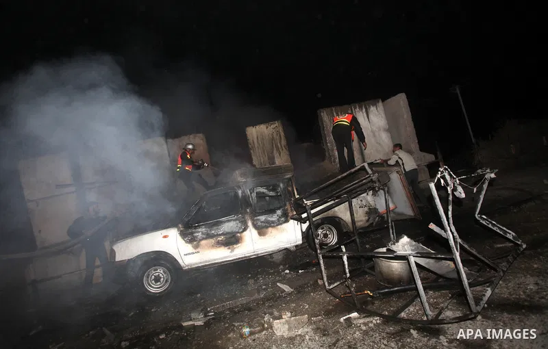 Palestinians extinguish a fire after Israeli air strikes targeted an electricity generator that fed the house of Palestinian Prime Minister in Gaza strip Ismail Haniyeh in Gaza City November 15, 2012. Israeli aircraft at...