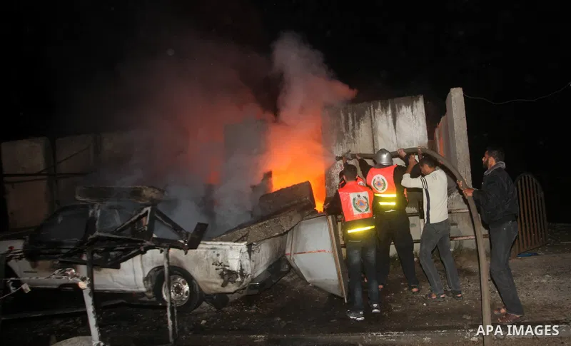 Palestinians extinguish a fire after Israeli air strikes targeted an electricity generator that fed the house of Palestinian Prime Minister in Gaza strip Ismail Haniyeh in Gaza City November 15, 2012. Israeli aircraft at...